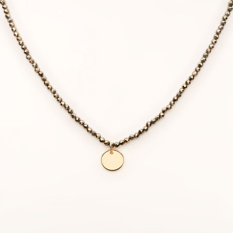 The Makery <br> Short beaded necklace with brushed brass disc <br> BRONZE